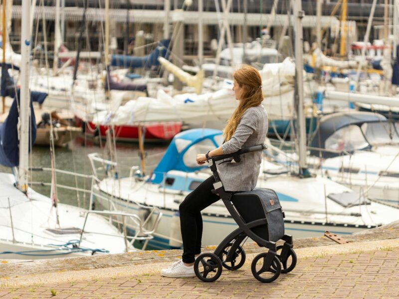 woman sitting on a rollator walker
