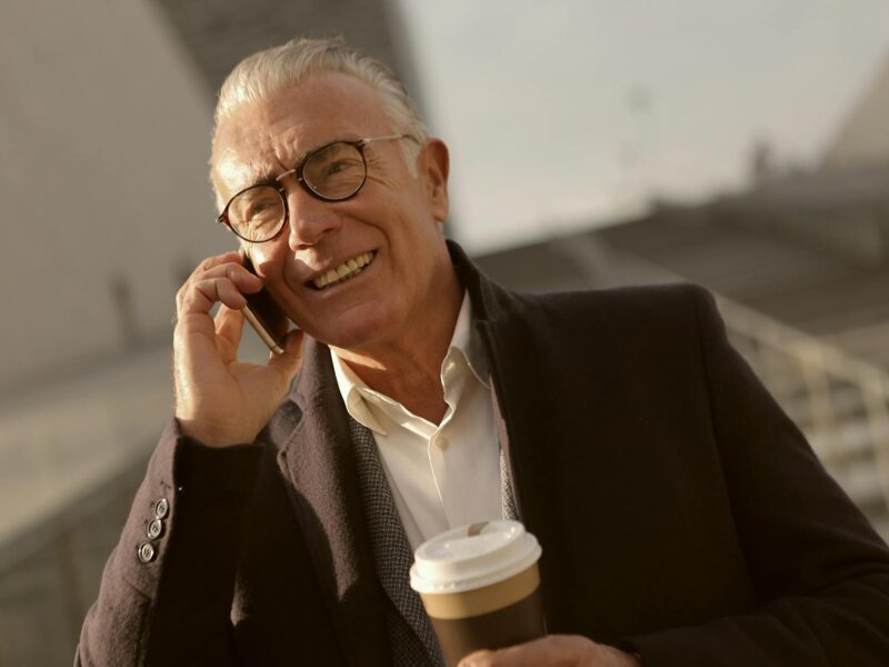 man in black suit jacket wearing eyeglasses
